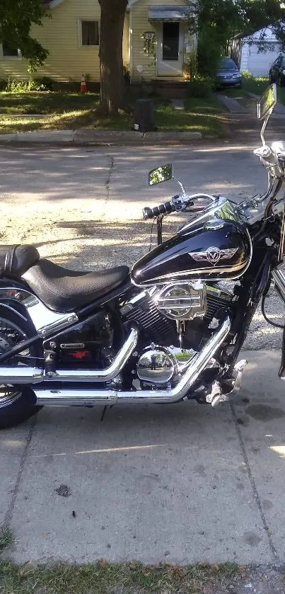 Shiny black motorcycle parked on a street.