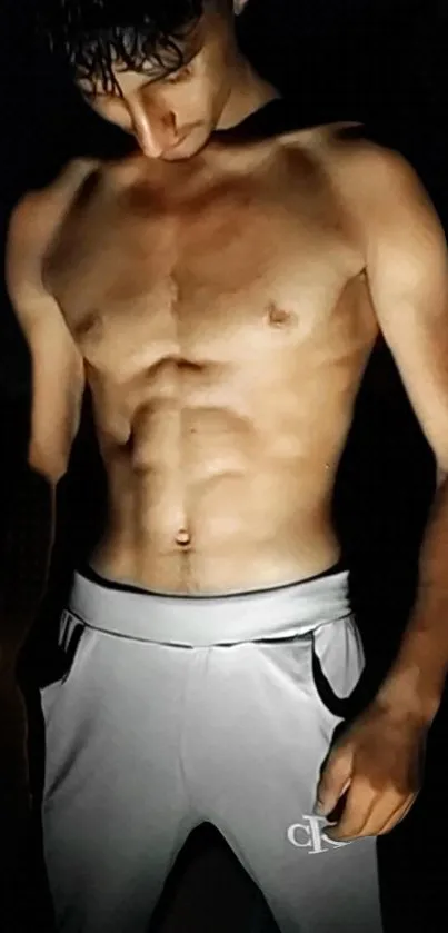 Shirtless man with defined abs in dark background.