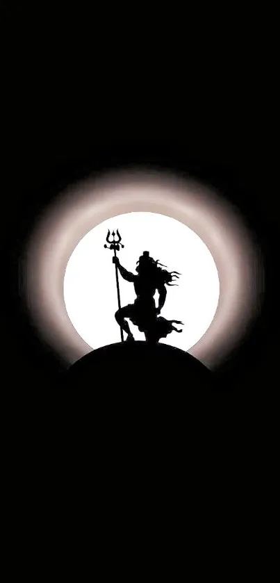 Silhouette of Shiva with trident against a glowing full moon.