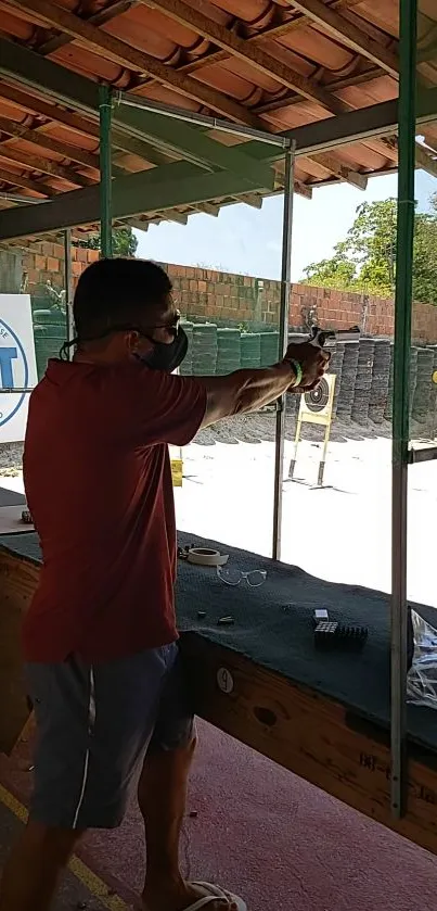 Man aiming a pistol at a shooting range in action.