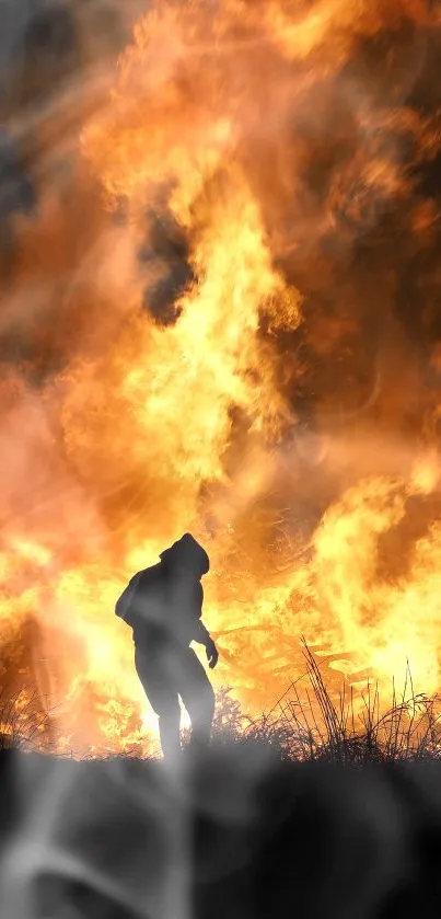 Silhouette of a person in front of a large, intense orange blaze.