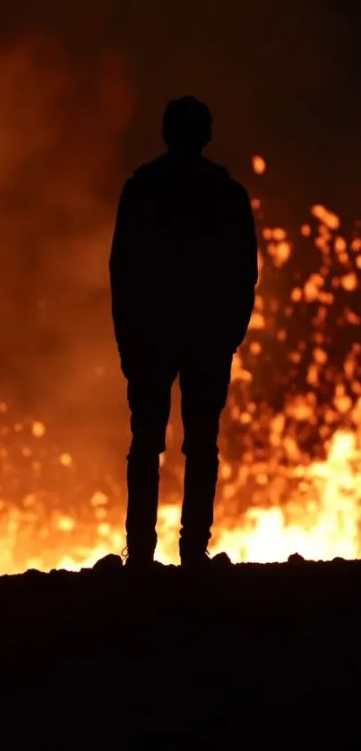 Silhouette of a person against a fiery orange background.