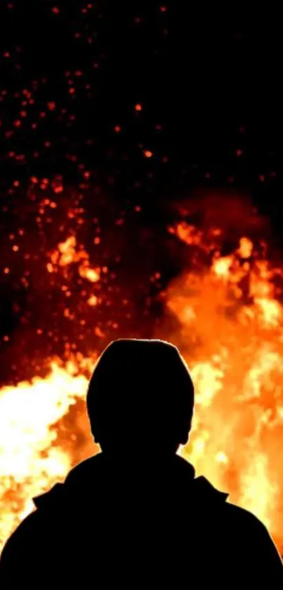 Silhouette of a person against a fiery background with bright flames.