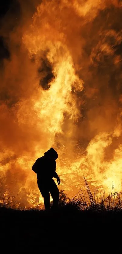 Silhouette of a person against a backdrop of intense, orange flames.