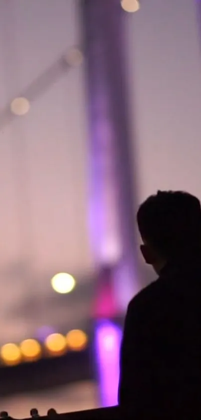 Silhouetted figure against a purple night sky with blurred lights.