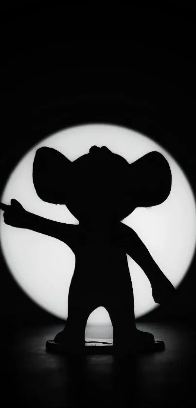 Silhouette of a playful figure against a monochrome background with a white circle.