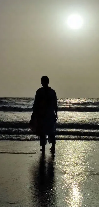 A serene silhouette at sunset on the beach.