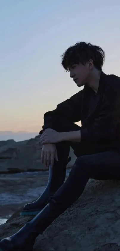 Silhouette of a person at sunset with a calm horizon.