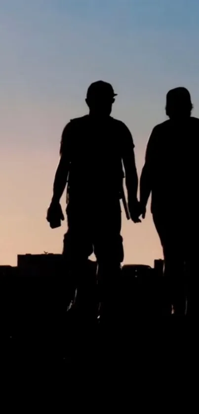 Silhouette of a couple walking at sunset with a city skyline.