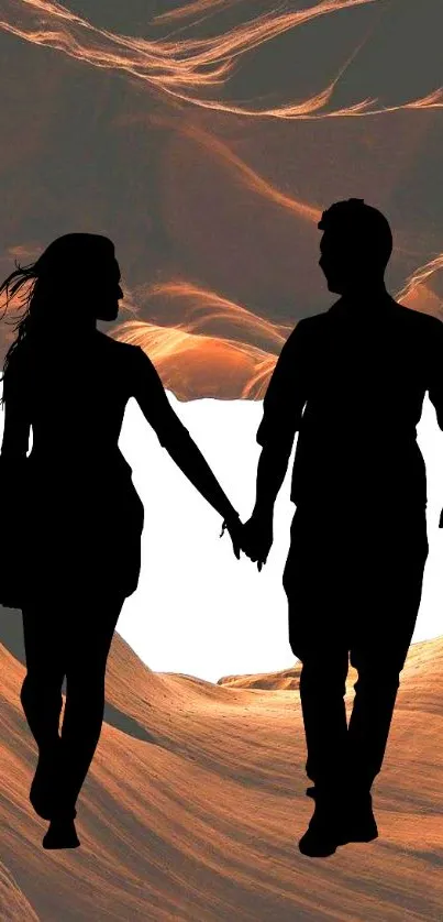 Silhouette of a couple in a canyon background, holding hands under an orange sky.