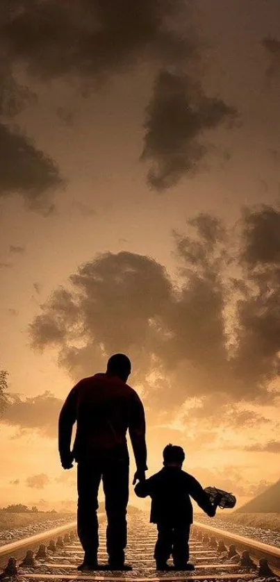 Father and child walking on railway tracks at sunset.