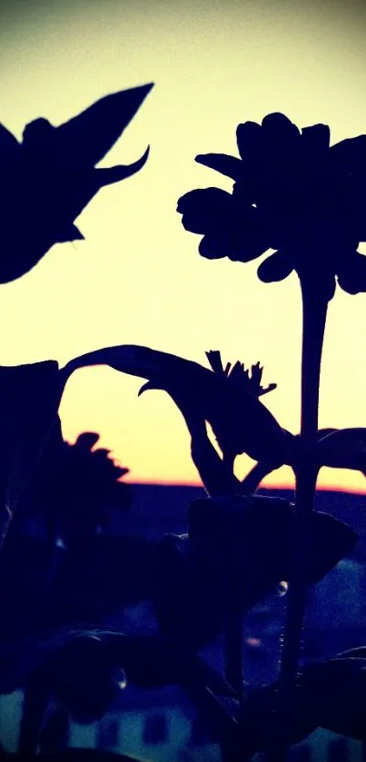 Silhouetted flowers against a vibrant sunset sky.