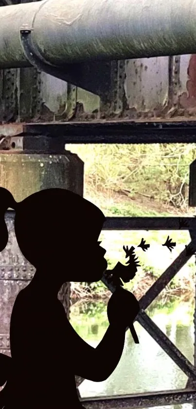 Silhouette of a girl with dandelions under an old iron bridge.