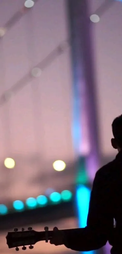 Silhouette of guitarist with colorful bridge at night