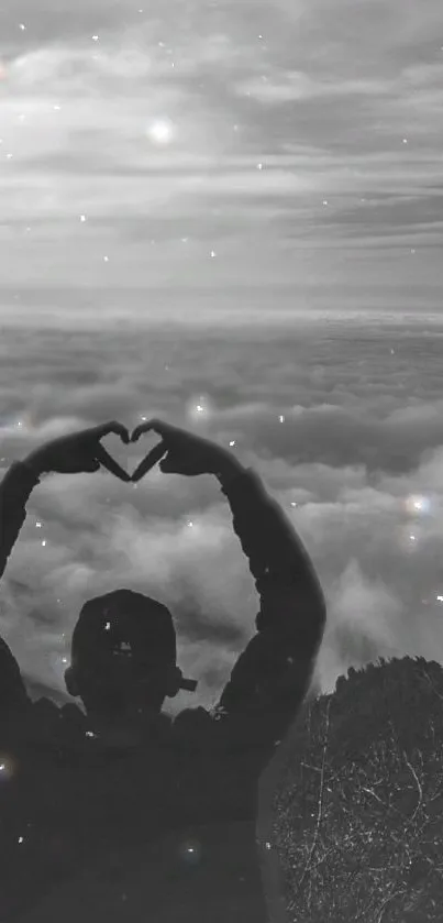 Silhouette forming heart over a cloudy sky with starry effect.