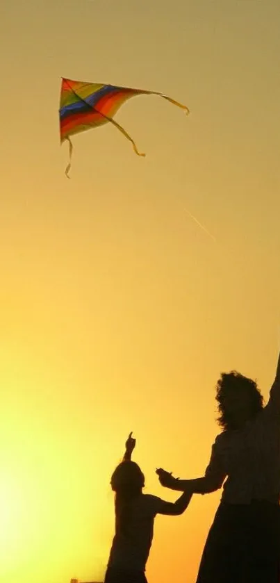 Silhouette of a child flying a kite against a vibrant orange sunset.