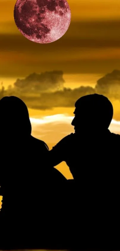 Silhouette couple at sunset with red moon in sky.