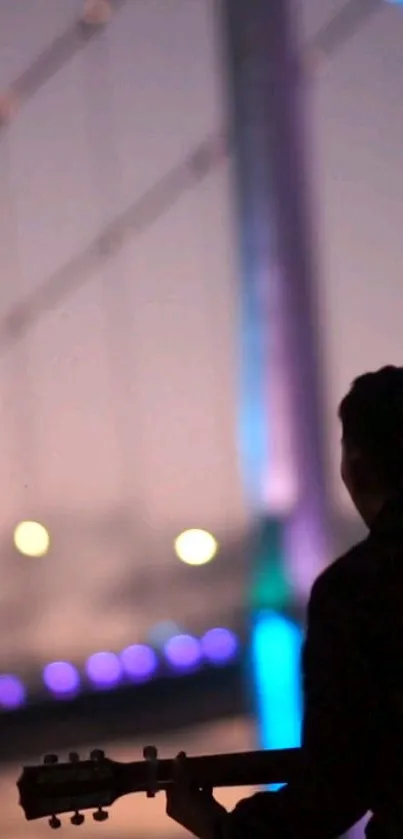 Silhouette of musician on a bridge with purple and blue lights.