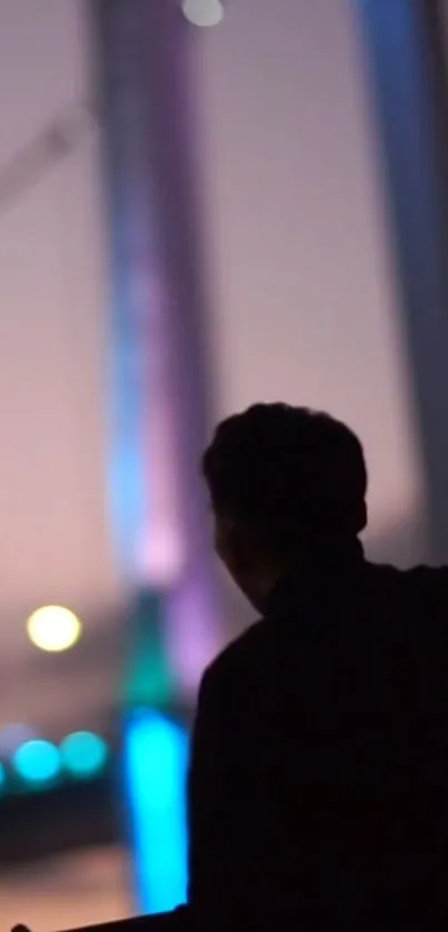 Silhouette of person against urban night backdrop with blurred lights.