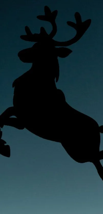 Silhouette of a leaping reindeer against a dark blue night sky.