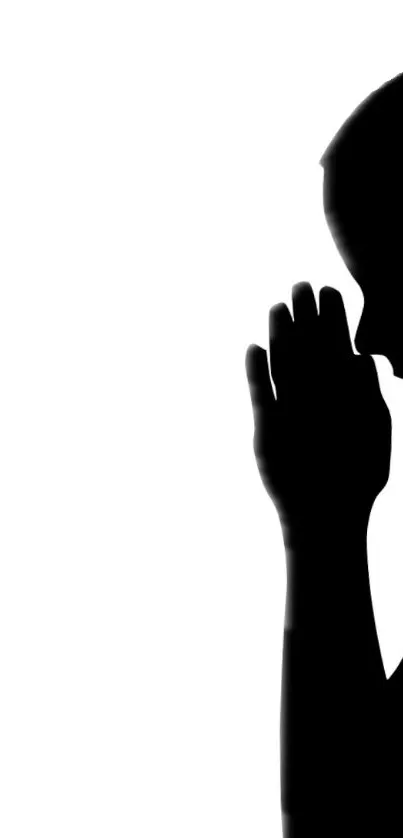 Silhouette of a person in prayer on a white background.