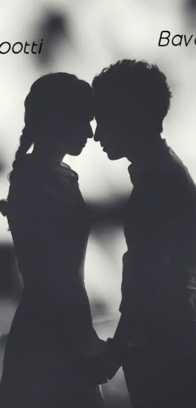 Romantic silhouette of couple in black and white wallpaper.