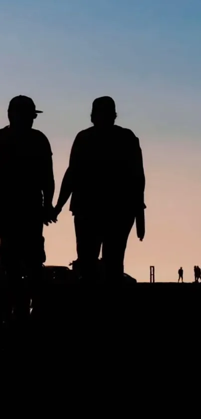 Silhouette couple against sunset sky, creating a picturesque mobile wallpaper.