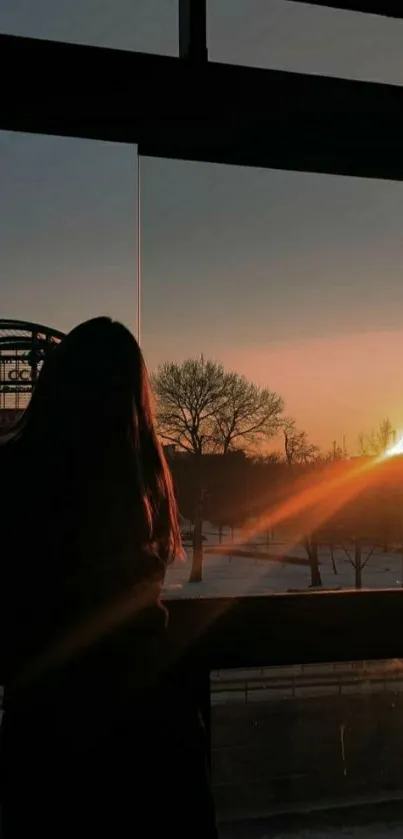 Silhouette against a sunrise through a window, capturing tranquil beauty.