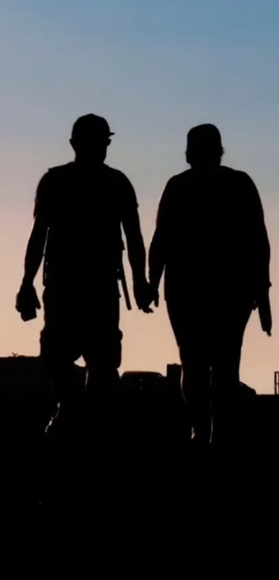 Silhouetted couple walking at sunset on mobile wallpaper.