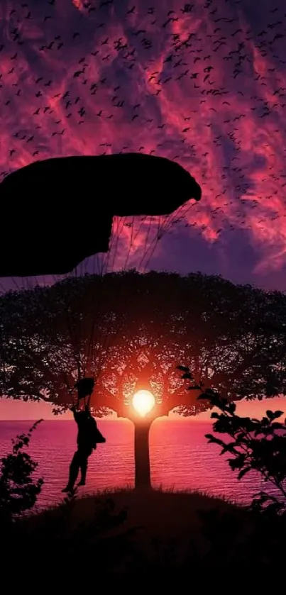 Silhouette of parachute against sunset with vivid purple and pink sky.