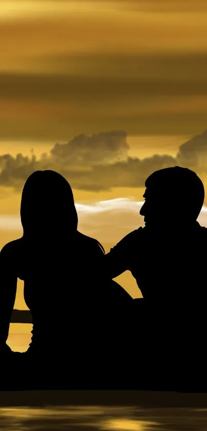 Silhouette of couple against a golden sunset sky in romantic scenery.