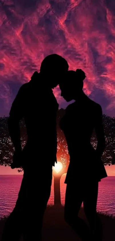 Silhouette of a couple embracing at sunset with a vibrant sky and serene scenery.