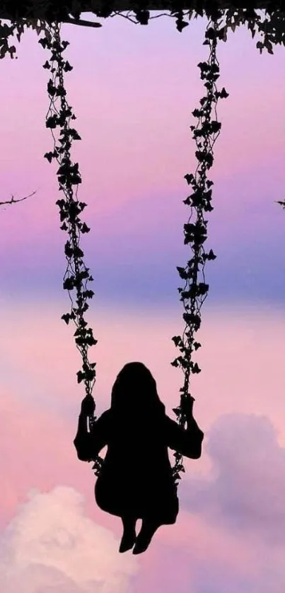 Silhouette of a girl swinging with a pink sunset sky backdrop.