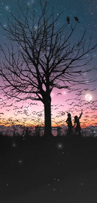 Silhouette of tree with birds under a vibrant night sky at sunset.