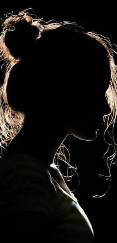 Silhouette of a woman with backlighting, artistic tone.