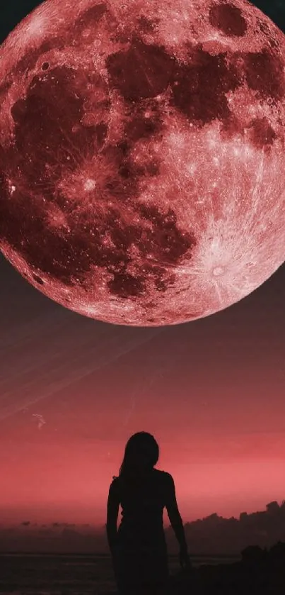 Silhouette of a person under a striking red moon in the night sky.