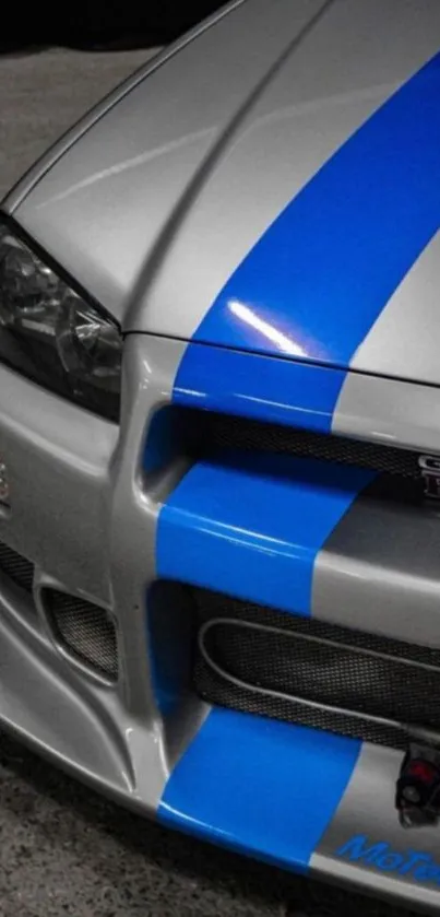 Close-up of silver and blue GT-R sports car with blue stripes.