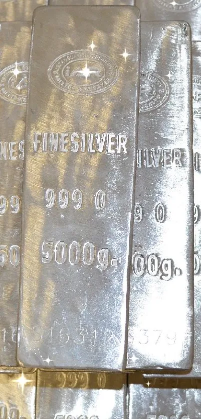 Stack of fine silver bars with shiny metallic surface.