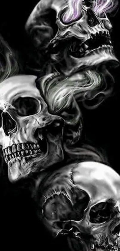 Silver skulls with smoke on dark background.