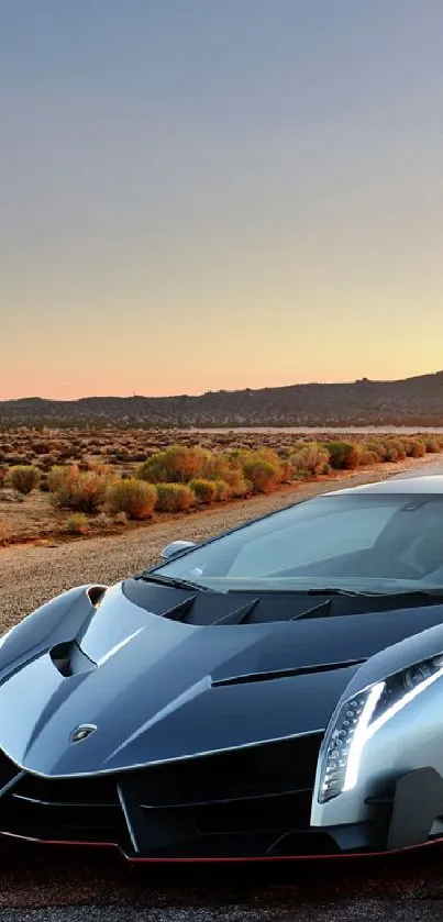 Silver sports car on a desert road at sunset.