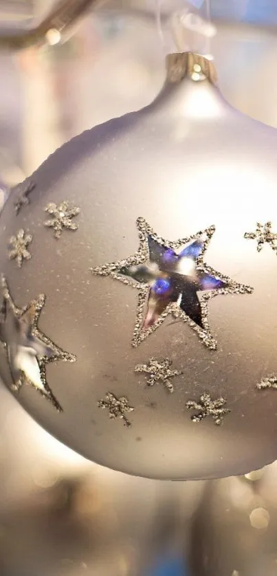 Silver ornament with star designs on a festive wallpaper.