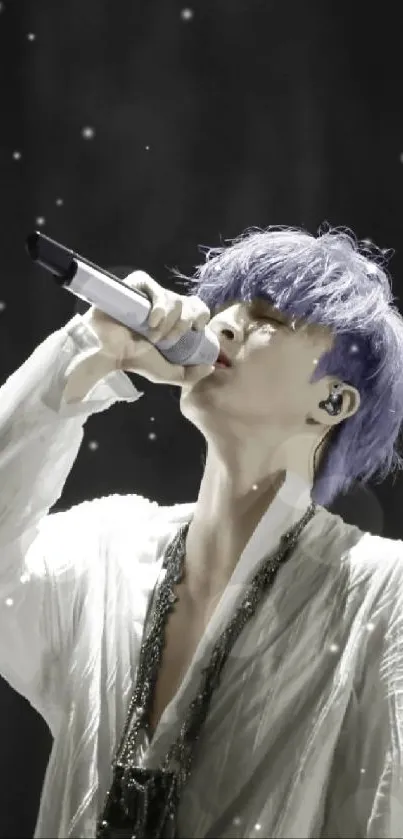 Singer with purple hair performs passionately under spotlight.