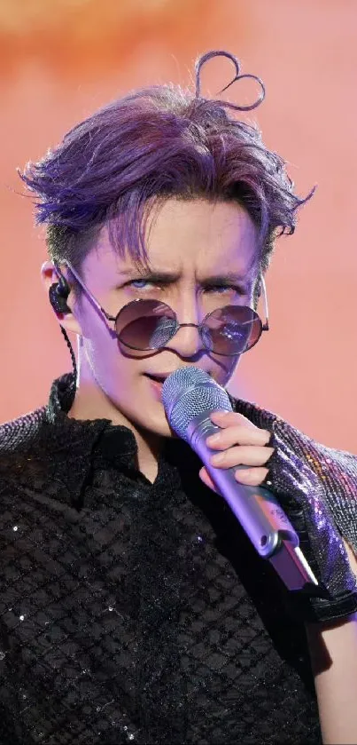 Stylish singer with sunglasses and mic on stage, vibrant background.