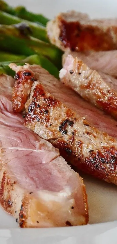 Close-up of juicy grilled steak slices with asparagus.