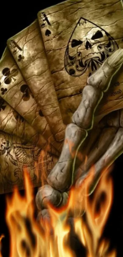 Skeleton hand holds poker cards with flames.