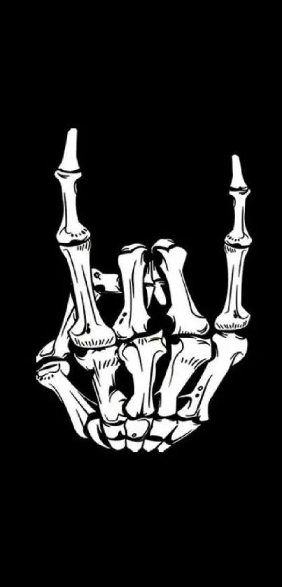 Skeleton hand rock sign on black background wallpaper.