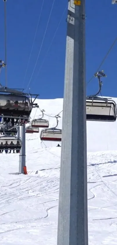 Ski lift ascending snowy mountain under blue sky, capturing winter adventure.