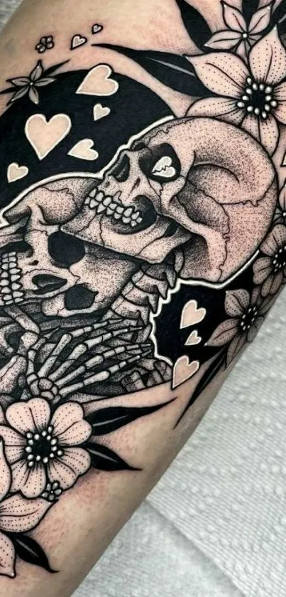 Black and white skull and floral tattoo art on arm.