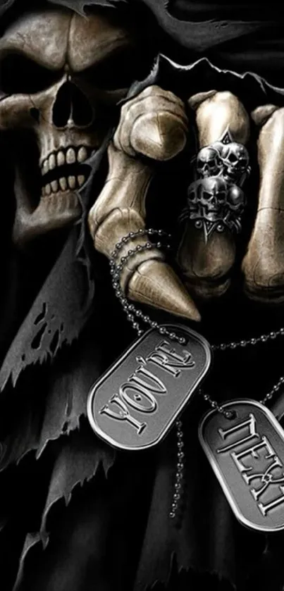 Dark skull hand holding dog tags with a gothic design.