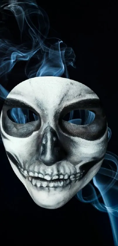 Skull mask surrounded by swirling smoke on black background.